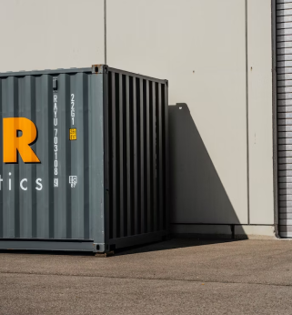 A container sitting in front of a building.