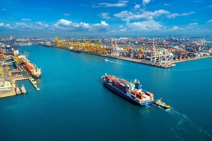 A bird's eye view of a bustling port with cargo ships, highlighting the significance of containerization in the shipping industry.