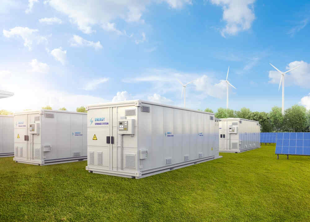 A cluster of white storage units arranged in an open field, resembling shipping containers found near cafes.