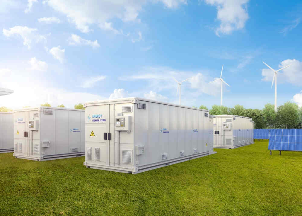 A group of white boxes in the grass.